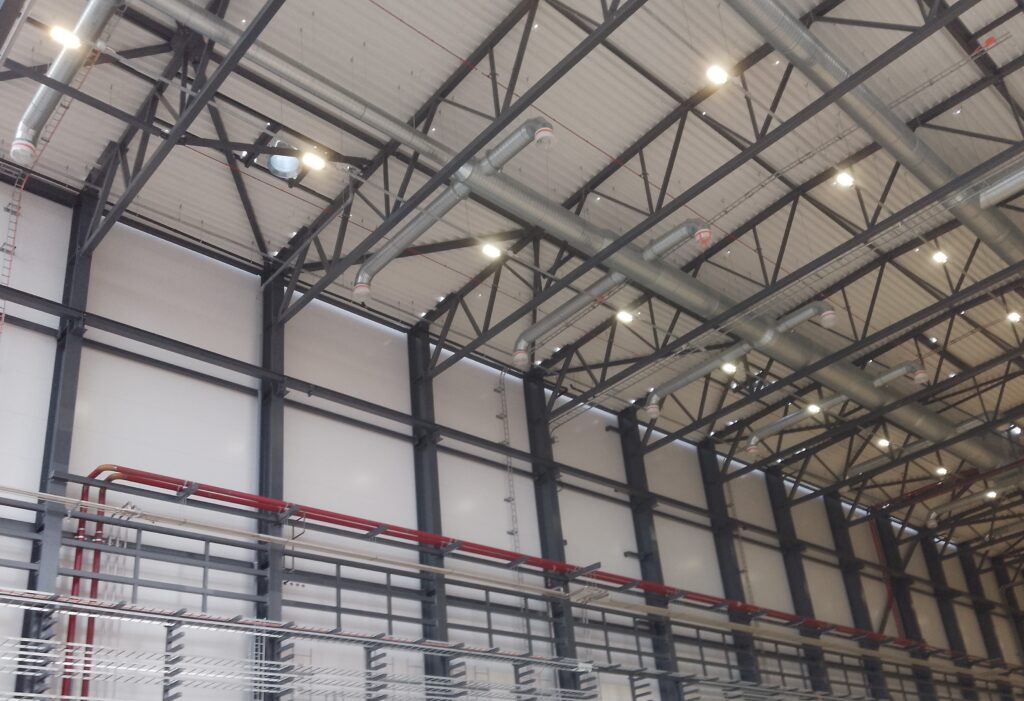 Building services installations near the ceiling of a hall.