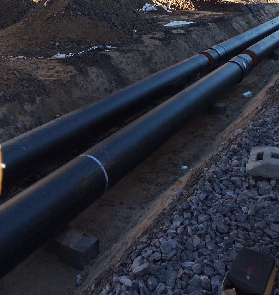Completed straight underground infrastructure pipeline in a dug trench.