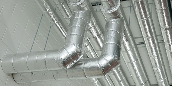 Insulated ventilation ducts installed near the ceiling.